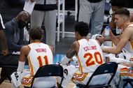Head coach Lloyd Pierce of the Atlanta Hawks speaks with his team under a timeout.